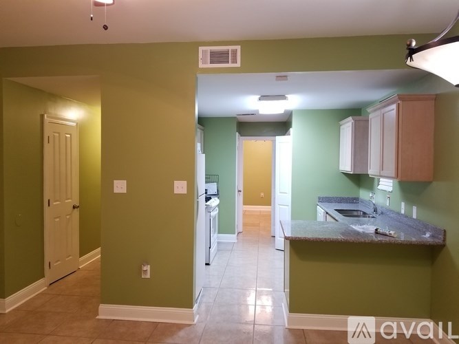 A kitchen with green walls and a counter top.