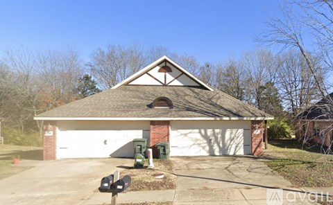 A two-car garage with a brick chimney and a white garage door.