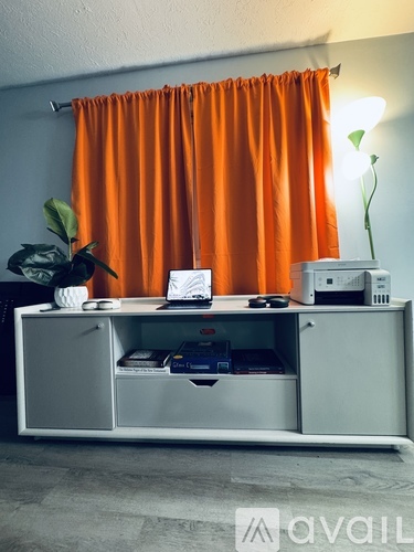 A white cabinet with a computer on top of it.