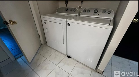 A white washing machine and dryer in a small laundry room.