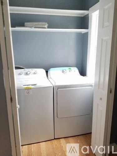 A small laundry room with two washing machines.