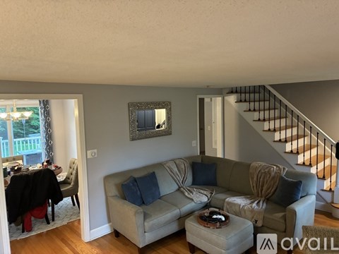 A living room with a grey couch and a coffee table.