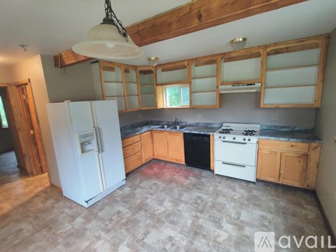 A kitchen with a white fridge and a white stove top oven.