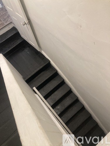 A set of stairs leading down to a darker floor.