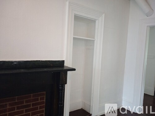 A room with a fireplace and a doorway.