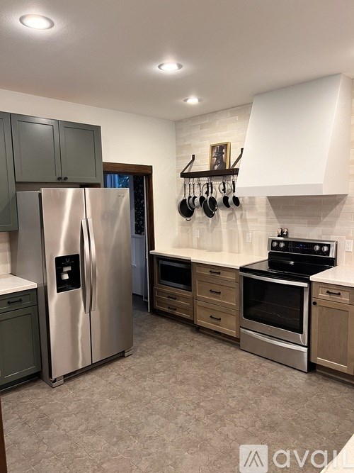 A bathroom with a glass shower door and a white sink.
