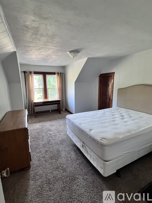 A modern kitchen with a stainless steel sink and a flat screen TV above the stove.