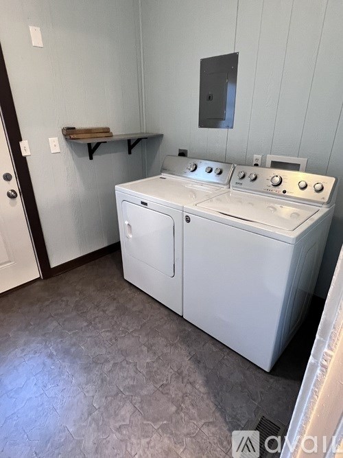 A white washer and dryer in a small laundry room.