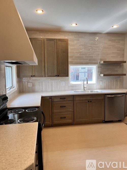 A kitchen with wooden cabinets and a stove top oven.