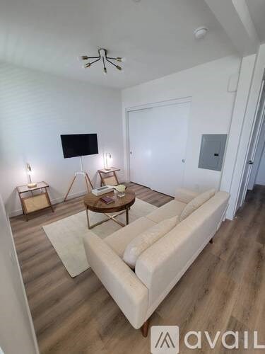 A living room with a white couch and a coffee table.