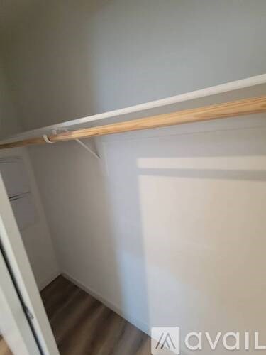 A white door is open to a hallway.