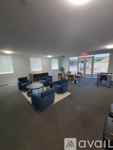 A large room with blue chairs and tables.