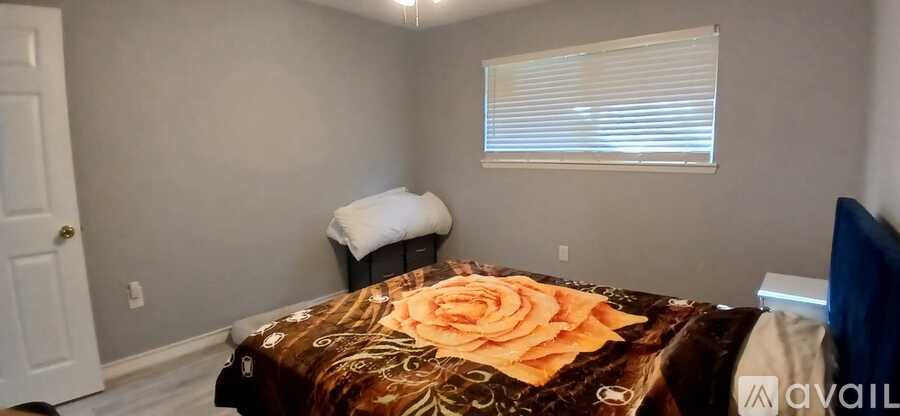 A bedroom with a bed and a white door.