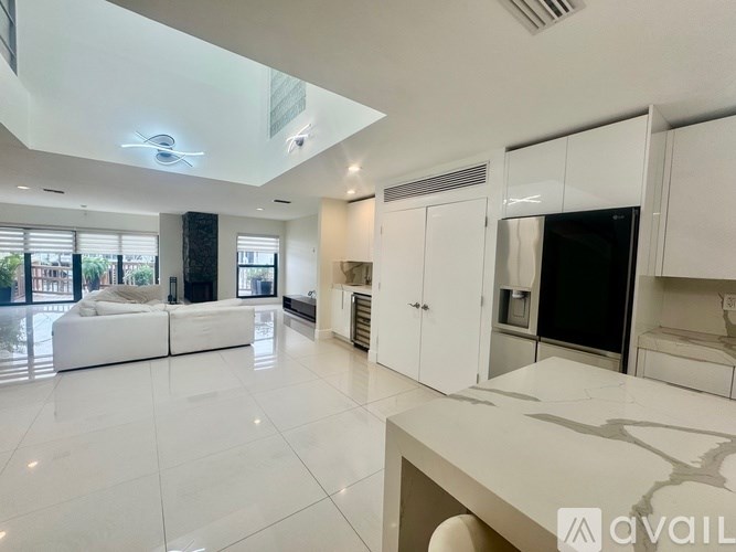 A spacious kitchen with white cabinets and a modern design.