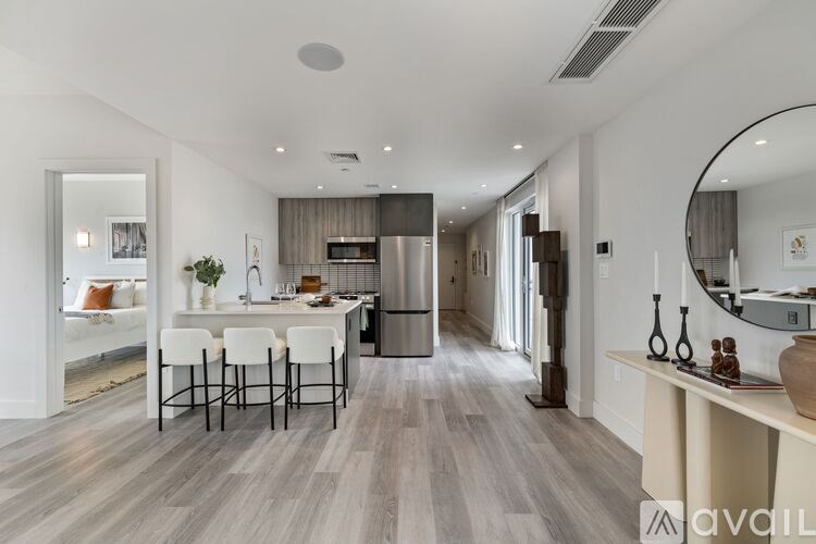 A modern kitchen with a dining table and chairs.