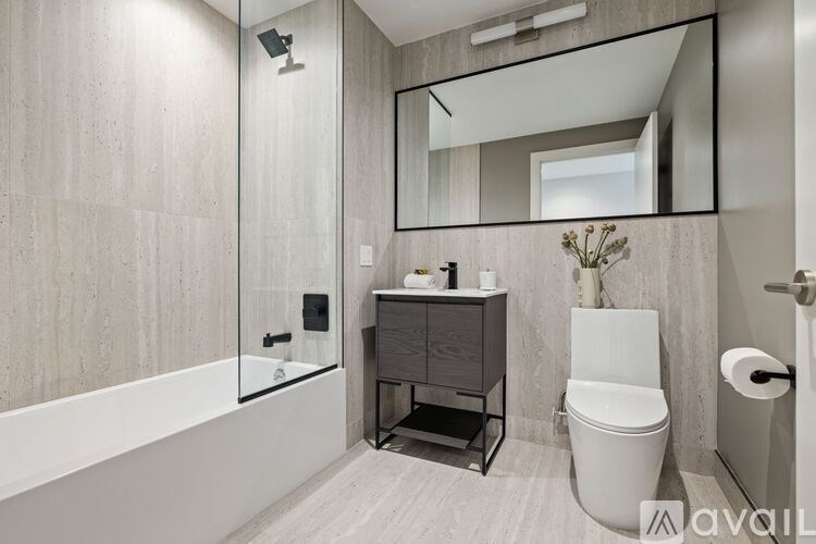 A bathroom with a tub, toilet, and sink.