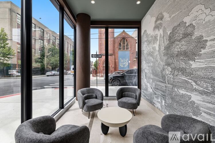 A room with a wall drawing and a table with four chairs.