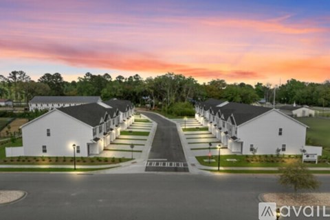 A row of houses are lined up on a street.