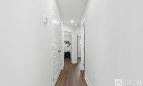 A long hallway with a black suitcase on the floor.