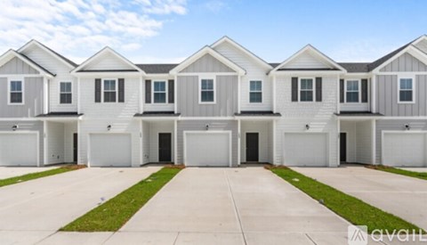 A row of identical houses with garages are available for rent.