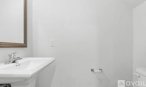 A white sink with a mirror above it.