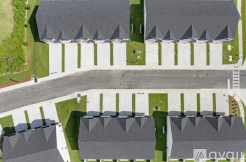 A row of houses with a road in between.