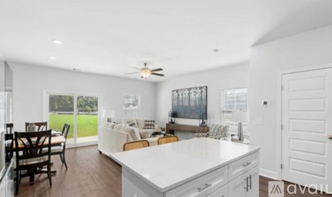 A modern kitchen with a dining table and chairs.