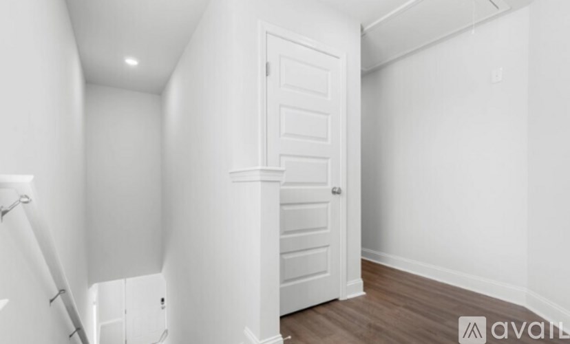 A white door is in a room with white walls.