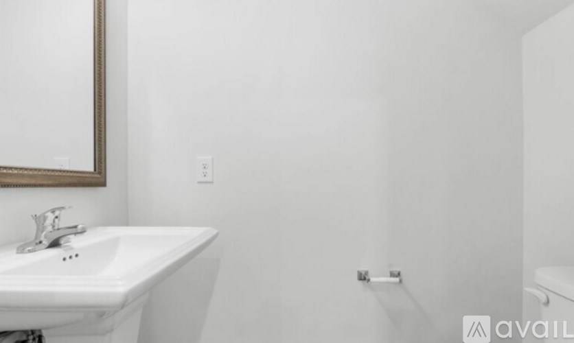 A white sink with a mirror above it.