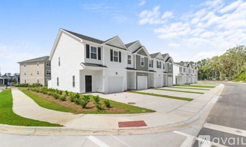 A row of houses with a clear blue sky above them.
