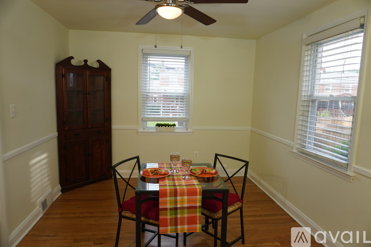 A dining room with a table set for a meal.