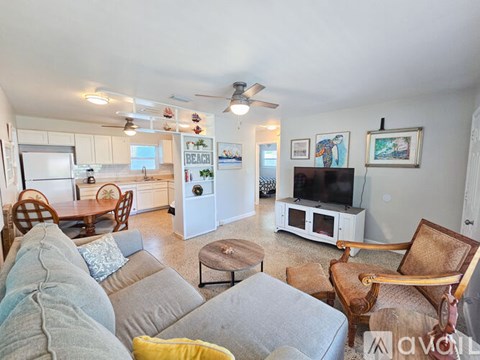 A living room with a grey couch and a television.