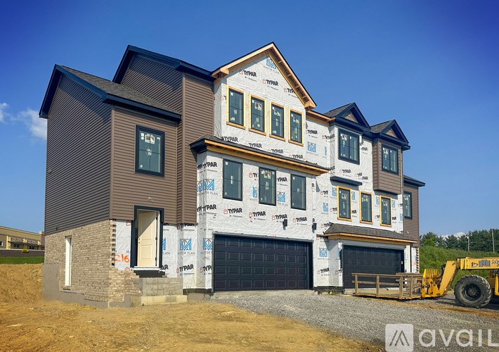 A house under construction with the brand "AVAIL" visible on the wall.