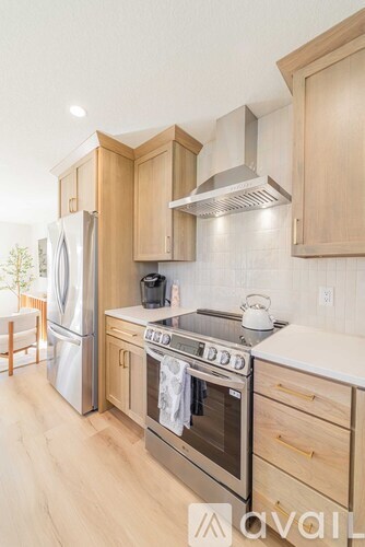 A kitchen with wooden cabinets and stainless steel appliances.