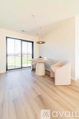 A modern dining room with a table and chairs.