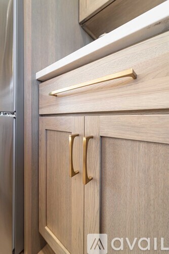 A kitchen drawer with a handle and a handle on the cabinet.