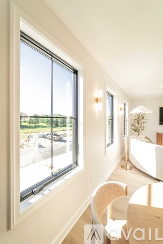 A sunny day outside a large window in a well lit room.