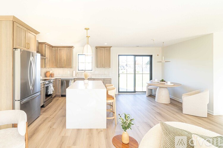 A modern kitchen with wooden cabinets and a large island.