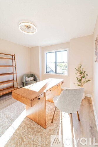 A room with a desk and chair in it.