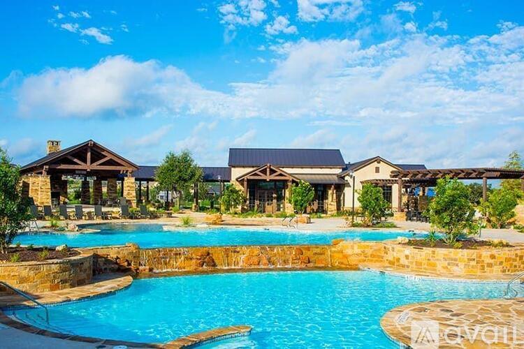 A large swimming pool in front of a resort-style building.