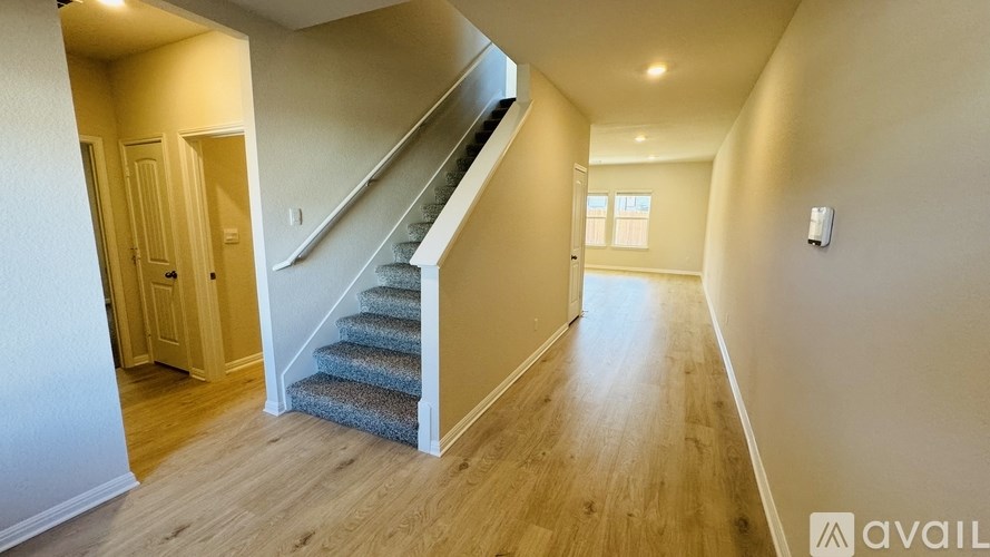 A spacious hallway with a staircase leading to the second floor.