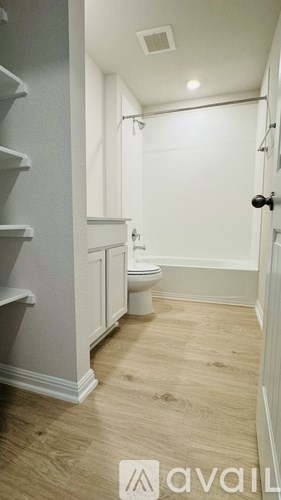 A white bathroom with a toilet and sink.