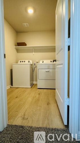 A small kitchen with a washer and dryer.