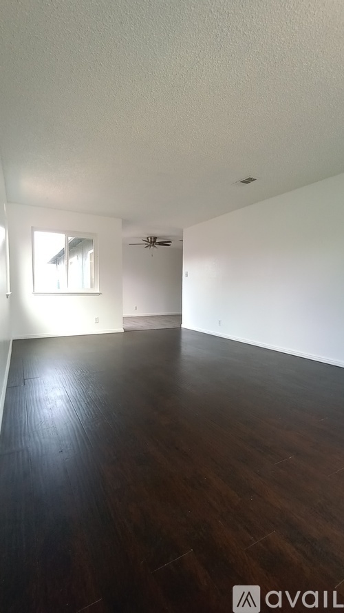 A room with wooden floors and a window.