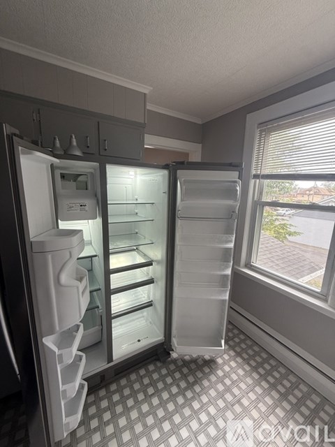 A refrigerator with its door open in a kitchen.