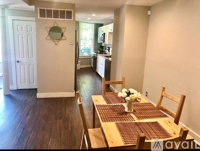 A dining room with a table set for two.