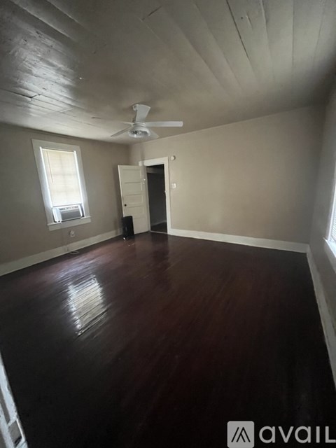 A room with wooden floors and a ceiling fan.