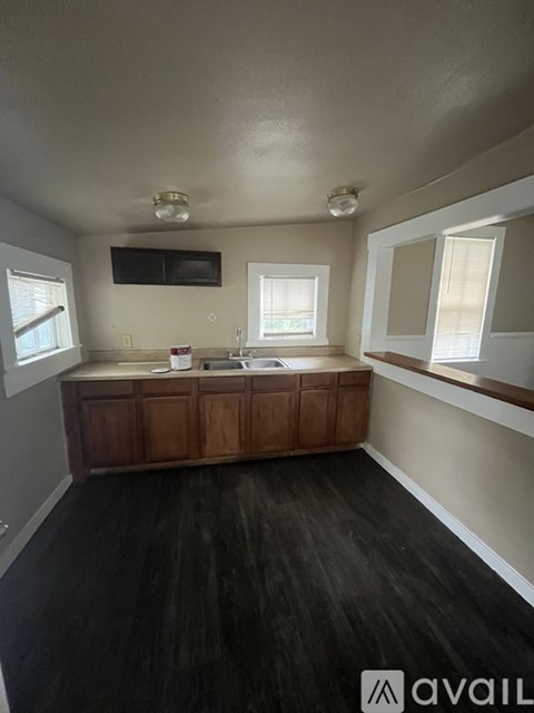 A kitchen with wooden cabinets and a countertop.