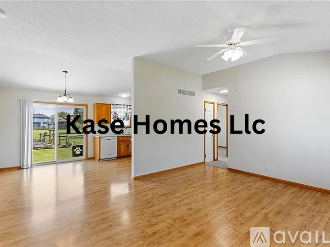 A room with a ceiling fan and a sign that says Kase Homes Llc.