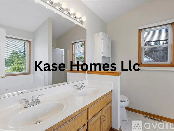 A bathroom with a white sink and a mirror above it.